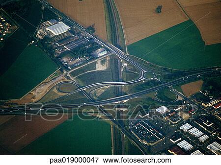 Stock Photo - Birdseye view of field, buildings, roads. Fotosearch