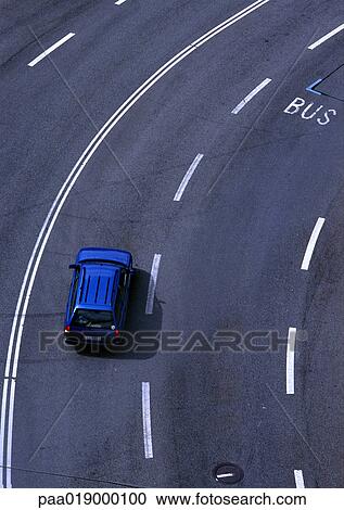 Stock Image - Blue car on highway, birdseye view.. Fotosearch