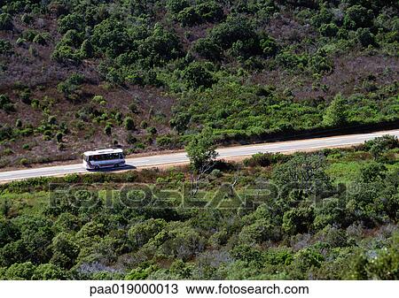 Bus traveling on mountainside road, blurry. View Large Photo Image Stock Image - Bus traveling on mountainside road, blurry.. Fotosearch