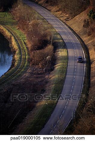 Car on hillside road. View Large Photo Image Stock Photography - Car on hillside road.. Fotosearch