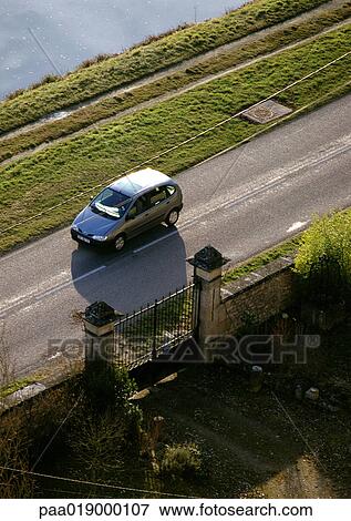 Car on road next to gate, high angle view View Large Photo Image Stock Photo - Car on road next to gate, high angle view. Fotosearch