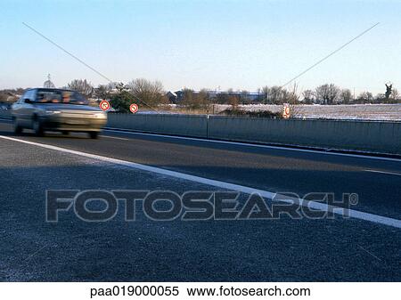 Stock Photography - Car traveling on highway, blurry.. Fotosearch