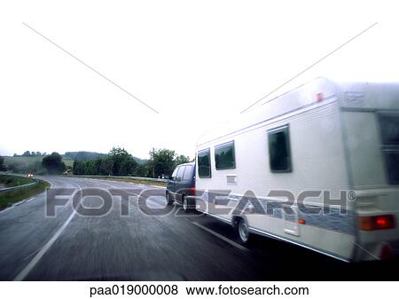 Car with mobile home driving on road, blurry. View Large Photo Image Stock Photo - Car with mobile home driving on road, blurry.. Fotosearch