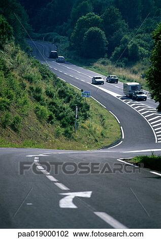 Stock Image - Cars on winding road.. Fotosearch