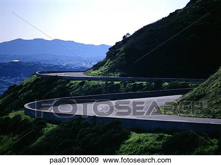 France, Corsica, road curving around mountain. View Large Photo Image Stock Photo - France, Corsica, road curving around mountain.. Fotosearch