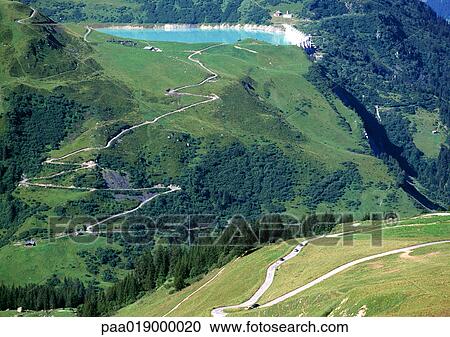 France, Savoie, roads through mountains, one leading to blue lake View Large Photo Image Stock Image - France, Savoie, roads through mountains, one leading to blue lake. Fotosearch