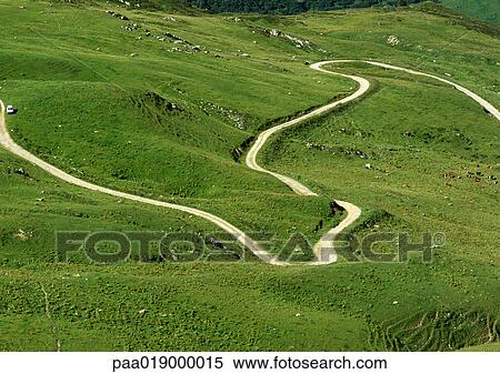 France, Savoie, winding road through grassy hills View Large Photo Image Stock Photography - France, Savoie, winding road through grassy hills. Fotosearch