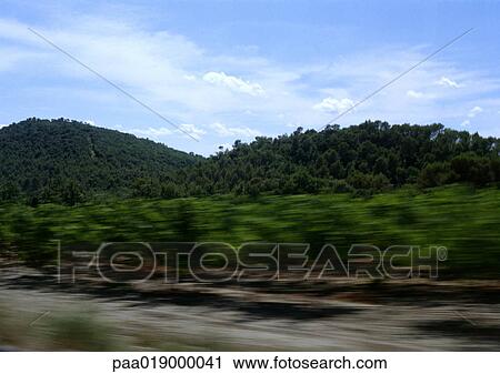 Green hills on side of road, blurry. View Large Photo Image Stock Image - Green hills on side of road, blurry.. Fotosearch