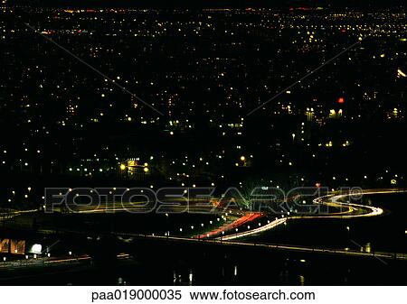 Light trails from cars traveling in a city at night, blurry. View Large Photo Image Stock Photography - Light trails from cars traveling in a city at night, blurry.. Fotosearch
