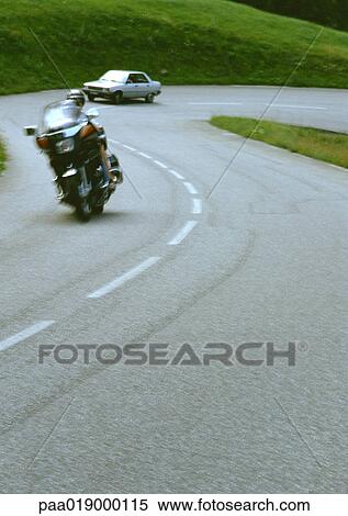 Motorcycle and car on winding road, blurred View Large Photo Image Stock Photography - Motorcycle and car on winding road, blurred. Fotosearch