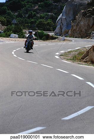 Motorcycle on winding road View Large Photo Image Stock Image - Motorcycle on winding road. Fotosearch