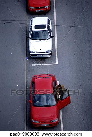 Stock Photo - Red and white cars parked on asphalt, birdseye view.. Fotosearch