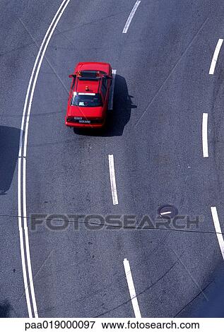 Red car on road with white lines, high angle view, full frame View Large Photo Image Stock Photo - Red car on road with white lines, high angle view, full frame. Fotosearch