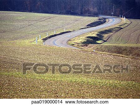 Road through crop fields View Large Photo Image Picture - Road through crop fields. Fotosearch