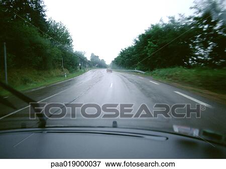 Road through woods, view from car View Large Photo Image Stock Photo - Road through woods, view from car. Fotosearch