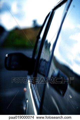 Side of car and rear view mirror, close-up View Large Photo Image Picture - Side of car and rear view mirror, close-up. Fotosearch