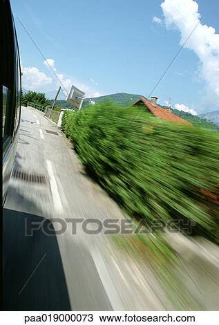 Side of road seen from moving vehicle, blurry. View Large Photo Image Stock Image - Side of road seen from moving vehicle, blurry.. Fotosearch