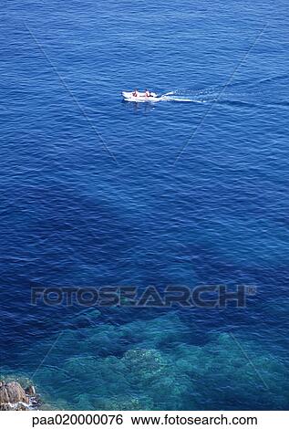 Stock Photograph - Corsica, boat in sea, high angle view. Fotosearch