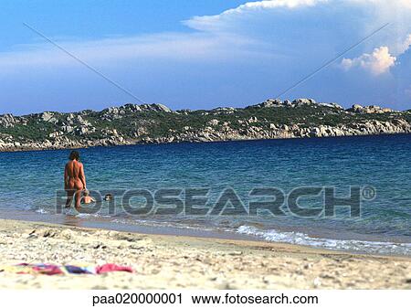 France, Corsica, people wading at nude beach Stock Photo 