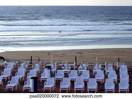Stock Image - Lounge chairs on beach. Fotosearch