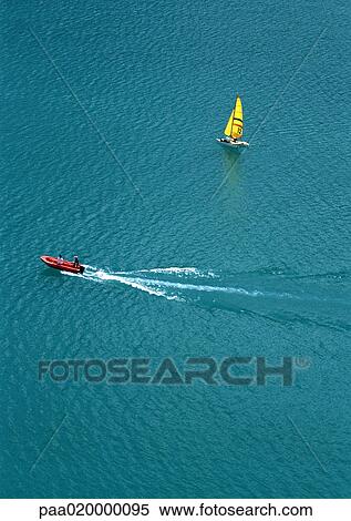 Motor boat and sail boat at sea, high angle view View Large Photo Image Stock Photography - Motor boat and sail boat at sea, high angle view. Fotosearch