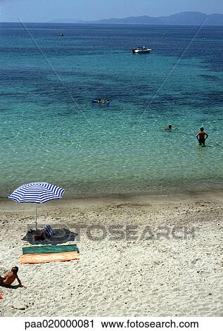 Stock Image - People at beach. Fotosearch