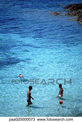 Stock Image - People wading in sea. Fotosearch