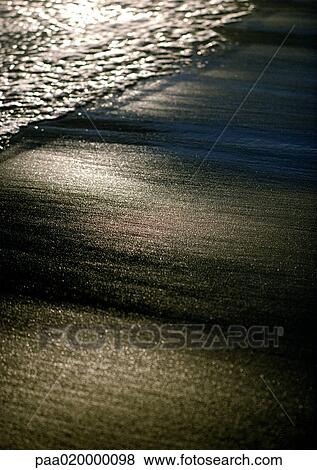 Stock Photo - Sand and surf, close-up. Fotosearch