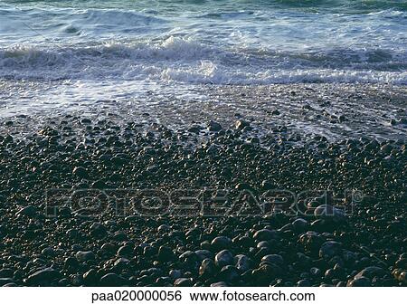 Stock Photograph - Surf on pebbly beach. Fotosearch