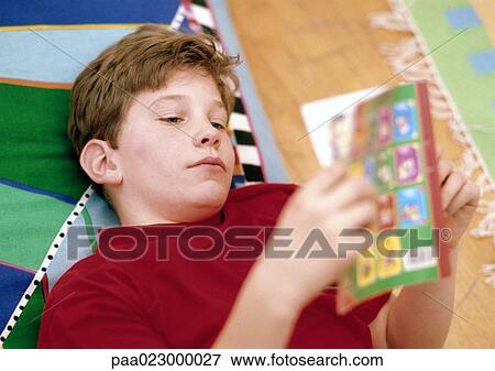 Boy reading in bed. View Large Photo Image Stock Photo - Boy reading in bed.. Fotosearch