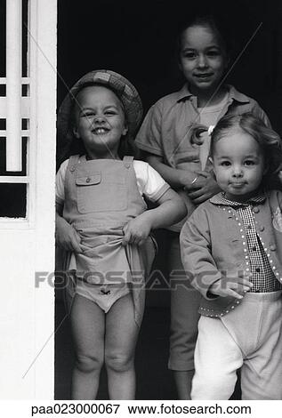 Children standing in doorway, black and white portrait. View Large Photo Image Stock Photo - Children standing in doorway, black and white portrait.. Fotosearch