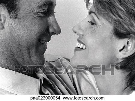Couple facing each other, black and white. View Large Photo Image Picture - Couple facing each other, black and white.. Fotosearch