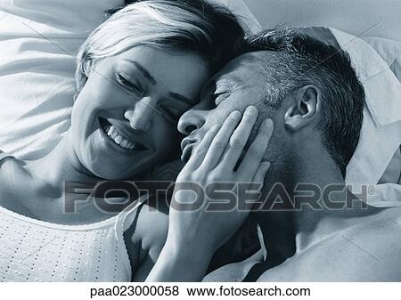Couple lying in bed together, black and white. View Large Photo Image Stock Photo - Couple lying in bed together, black and white.. Fotosearch