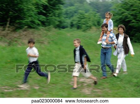 Picture - Family walking together outside.. Fotosearch