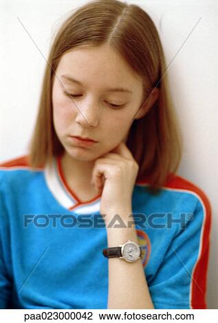 Girl holding hand to neck, looking down, portrait. View Large Photo Image Stock Image - Girl holding hand to neck, looking down, portrait.. Fotosearch