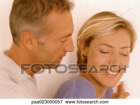 Man standing behind woman, woman smiling. View Large Photo Image Stock Photo - Man standing behind woman, woman smiling.. Fotosearch