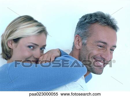Woman leaning on man's back, smiling. View Large Photo Image Stock Photography - Woman leaning on man's back, smiling.. Fotosearch