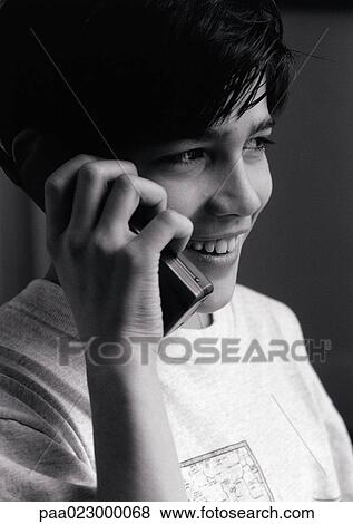 Young boy on cellular phone, close up black and white. View Large Photo Image Stock Photo - Young boy on cellular phone, close up black and white.. Fotosearch