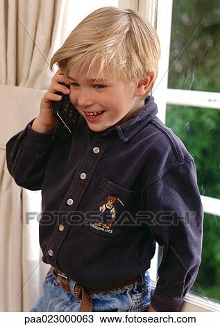 Young boy on cellular phone. View Large Photo Image Stock Image - Young boy on cellular phone.. Fotosearch
