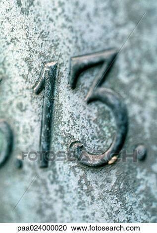 Stock Image - 13 text, embossed on stone.. Fotosearch