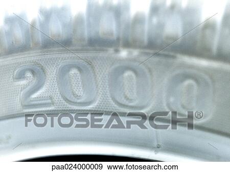 Stock Photo - 2000 text, embossed on white surface. Fotosearch