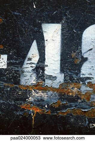 Stock Image - 4 text, stenciled on chipped, rusty surface. Fotosearch