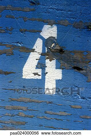 Stock Photograph - 4 text, stenciled on wood surface with peeling paint. Fotosearch