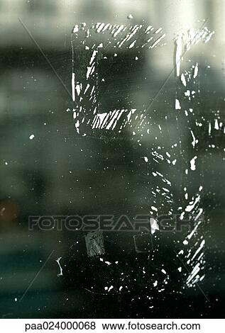 Stock Photo - 5 text, in worn away paint on glass surface. Fotosearch