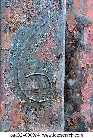 Picture - 6 text, embossed on flaking surface. Fotosearch