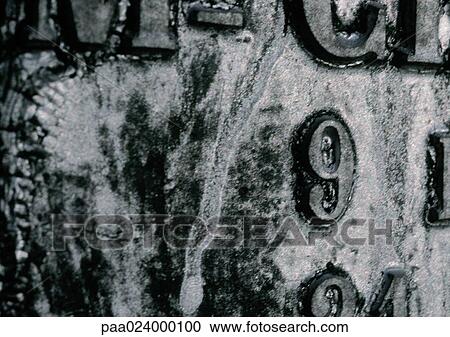 Stock Image - 9 text, embossed on mottled surface. Fotosearch