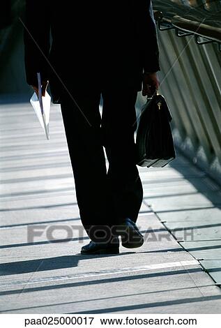 Stock Photo - Business man walking, lower half.. Fotosearch