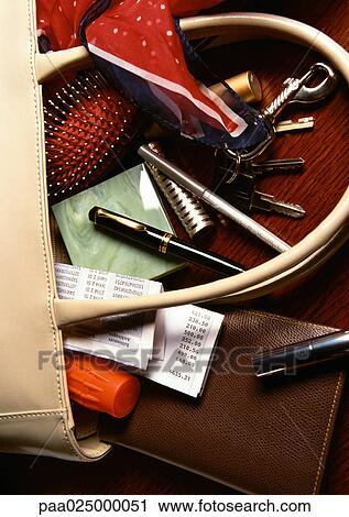Contents of woman's purse spilling out View Large Photo Image Stock Image - Contents of woman's purse spilling out. Fotosearch