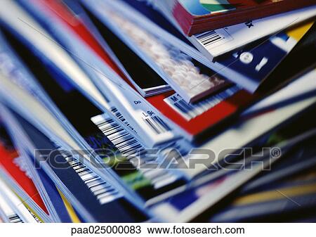 Stock Image - Disorderly stack of magazines, extreme close-up on corners with barcodes, full frame. Fotosearch