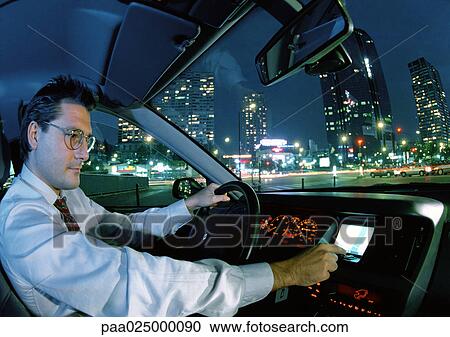 Man in car in city at night. View Large Photo Image Stock Image - Man in car in city at night.. Fotosearch